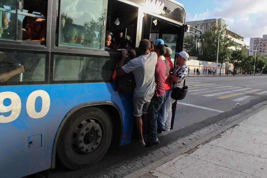   Varias personas colgadas de un ómnibus en La Habana, en medio de una severa crisis de combustible y transporte. Foto: AP/Ismael Francisco/Archivo. 